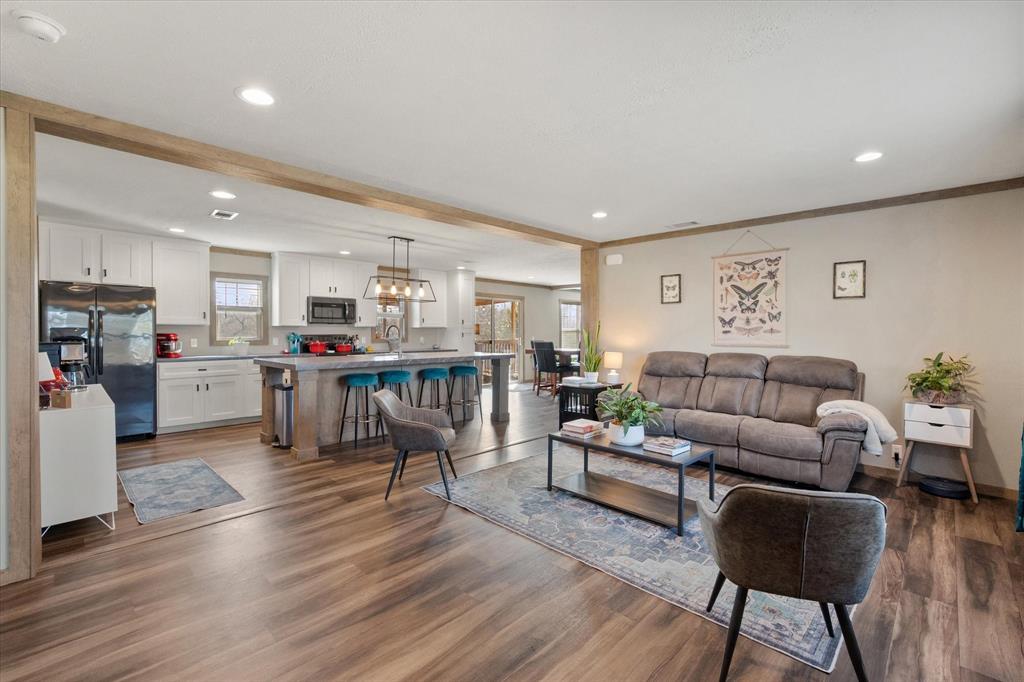 216 Southeast County Road Corsicana, TX 75109 - Photo 8 of 37 a living room with furniture and kitchen view with wooden floor