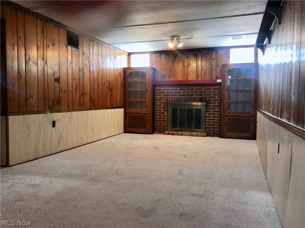 111 Sunset Road Avon Lake, OH 44012 - Photo 27 of 35 Recreation Room features Knotty Pine, Built Ins, Glass Block Windows, Wood burning Brick Fireplace & New Carpet!