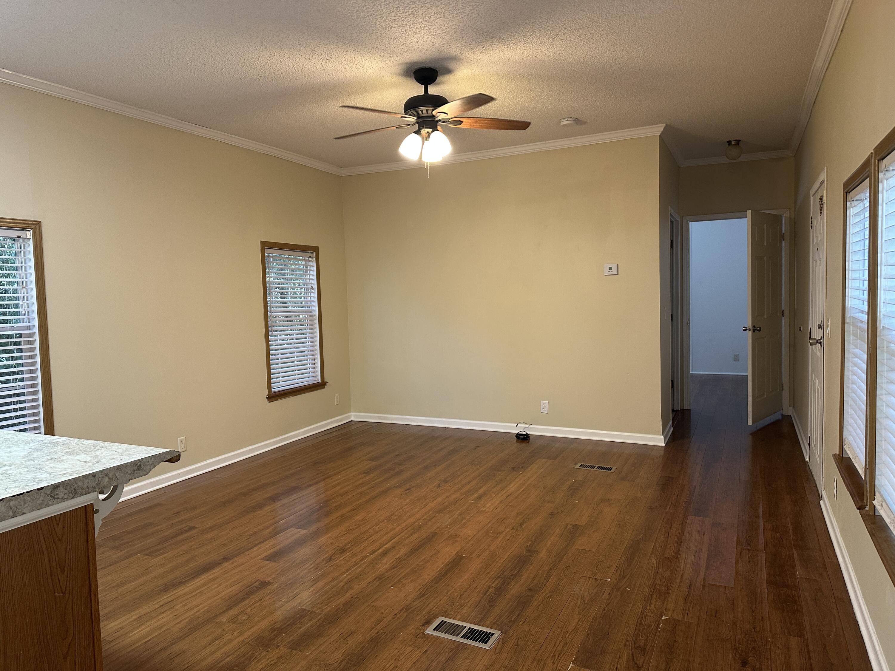 832 Cross Street, Unit A Destin, FL 32541 - Photo 11 of 15 wooden floor in an empty room with a window