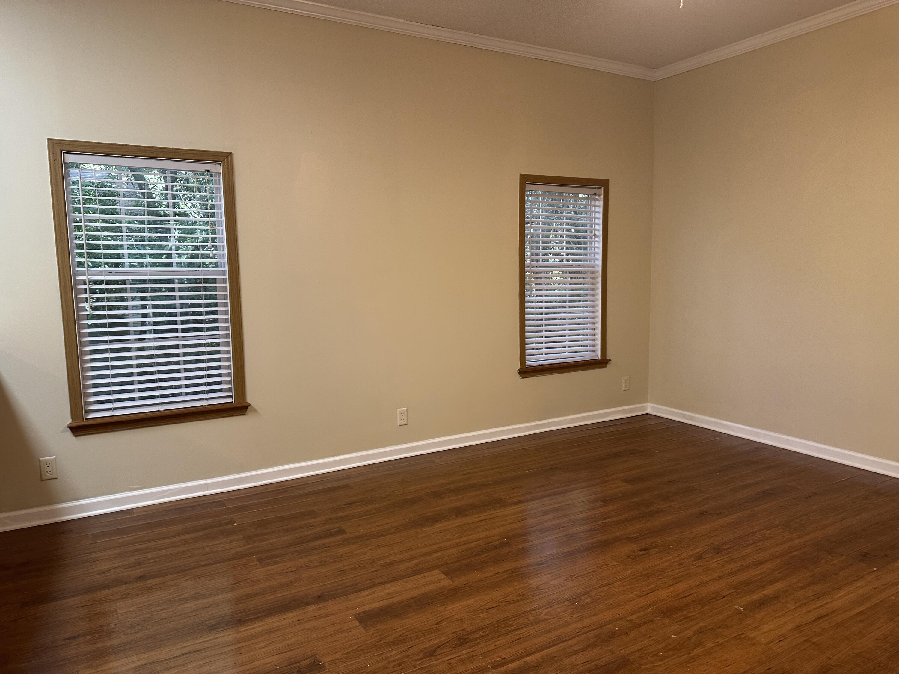 832 Cross Street, Unit A Destin, FL 32541 - Photo 12 of 15 a view of an empty room with wooden floor and a window
