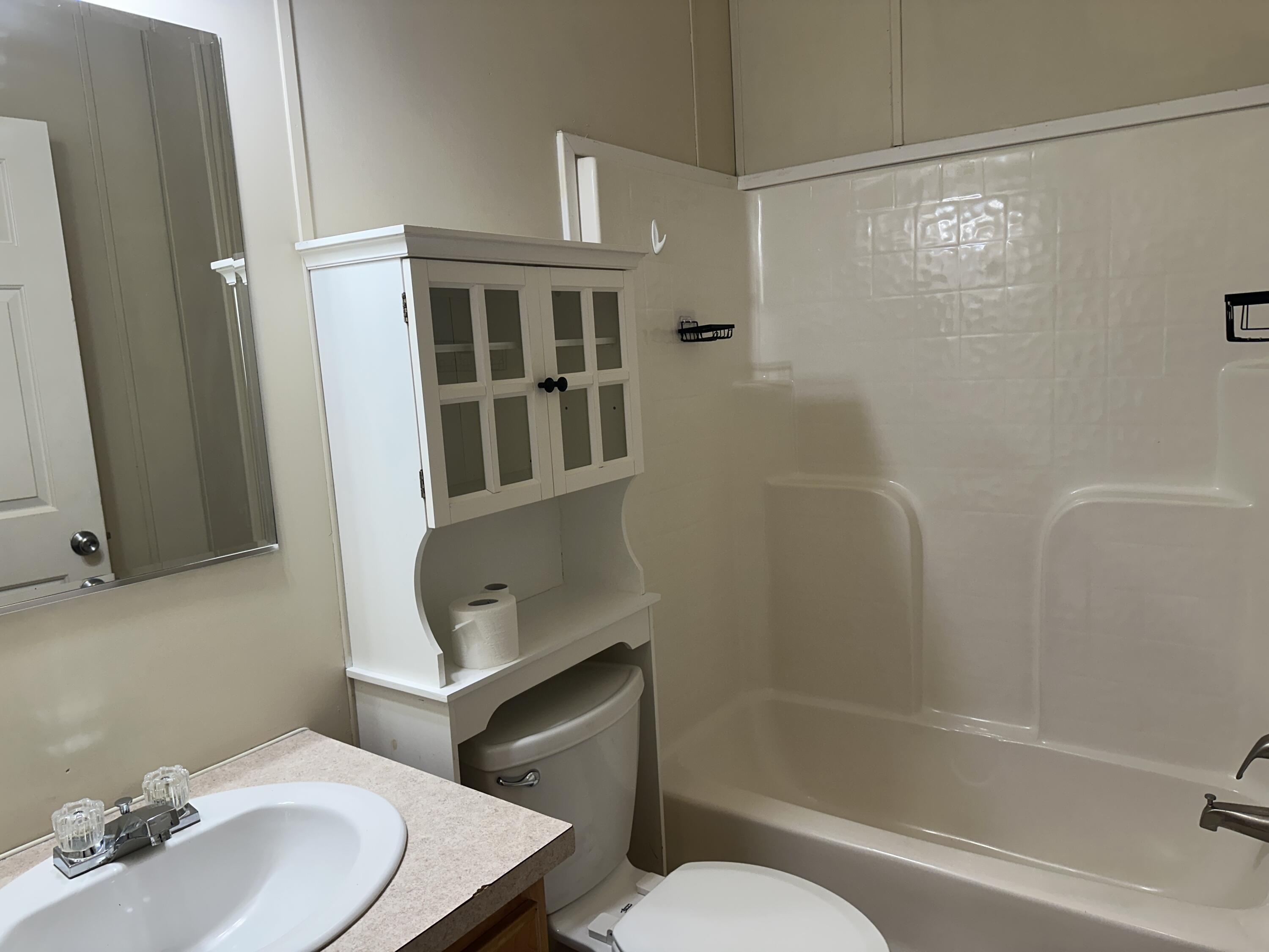 832 Cross Street, Unit A Destin, FL 32541 - Photo 14 of 15 a bathroom with a sink toilet and shower