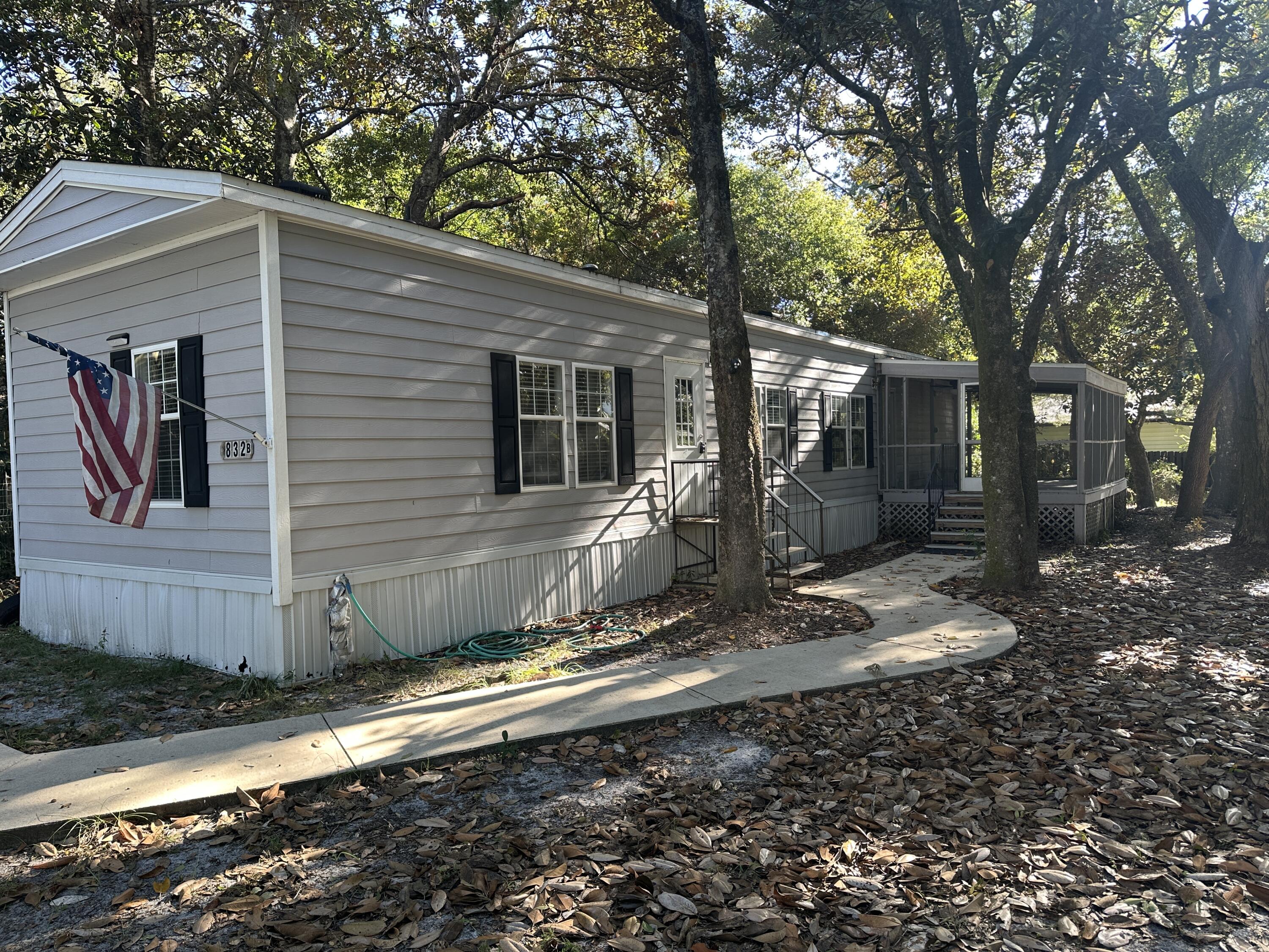 832 Cross Street, Unit A Destin, FL 32541 - Photo 2 of 15 a view of a barn house next to a yard with wooden fence