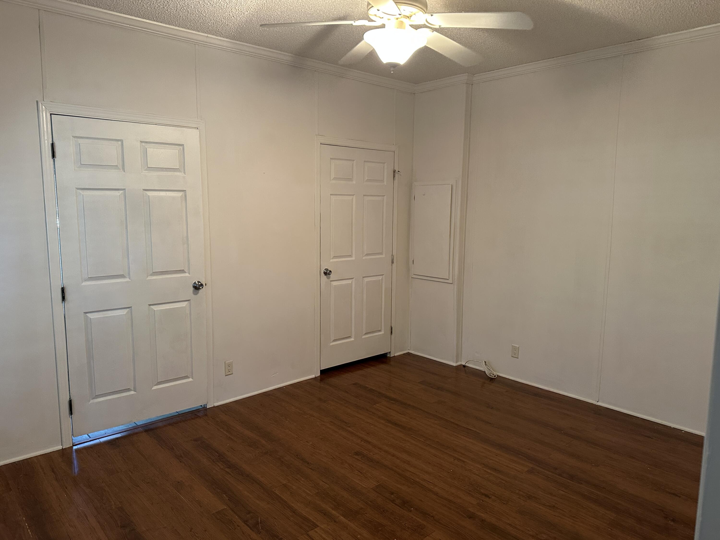 832 Cross Street, Unit A Destin, FL 32541 - Photo 4 of 15 an empty room with wooden floor and windows