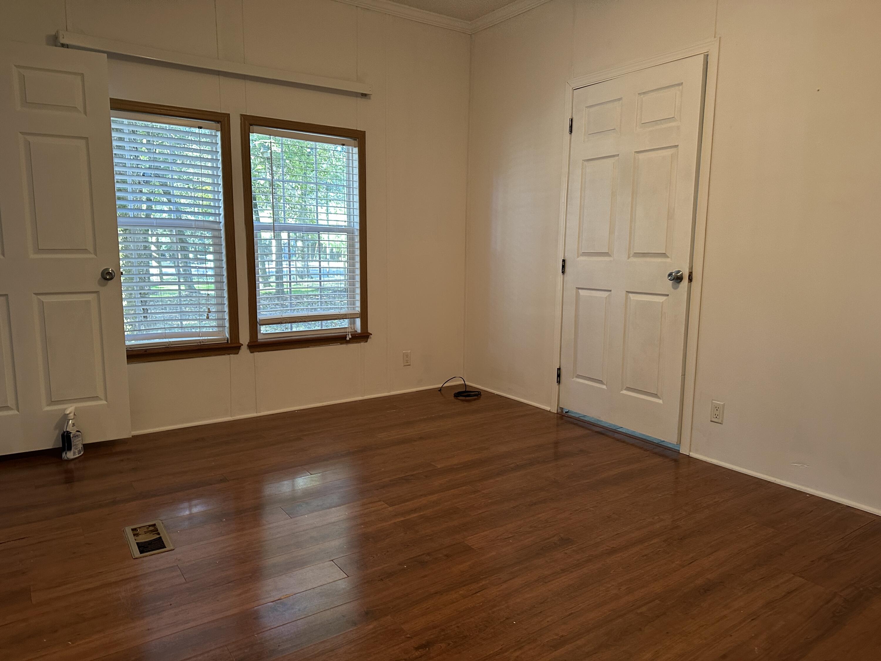 832 Cross Street, Unit A Destin, FL 32541 - Photo 5 of 15 an empty room with wooden floor and windows