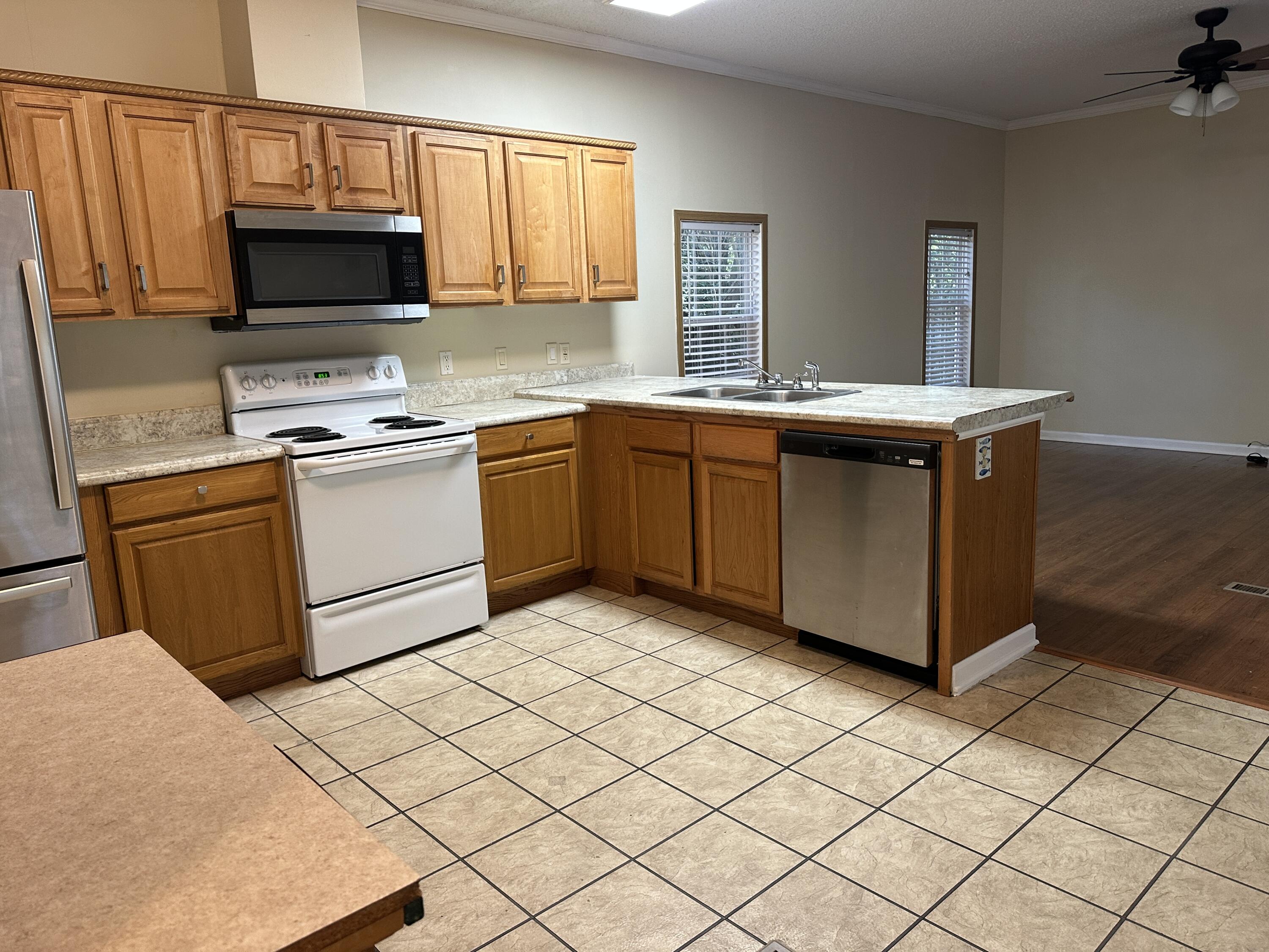 832 Cross Street, Unit A Destin, FL 32541 - Photo 9 of 15 a kitchen with stainless steel appliances granite countertop a stove a sink and a microwave