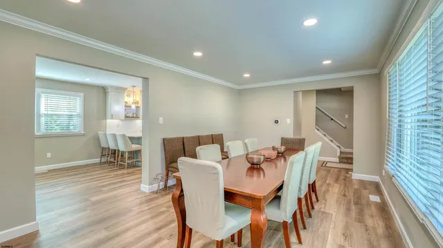 a bedroom with a large bed and a dresser with mirror