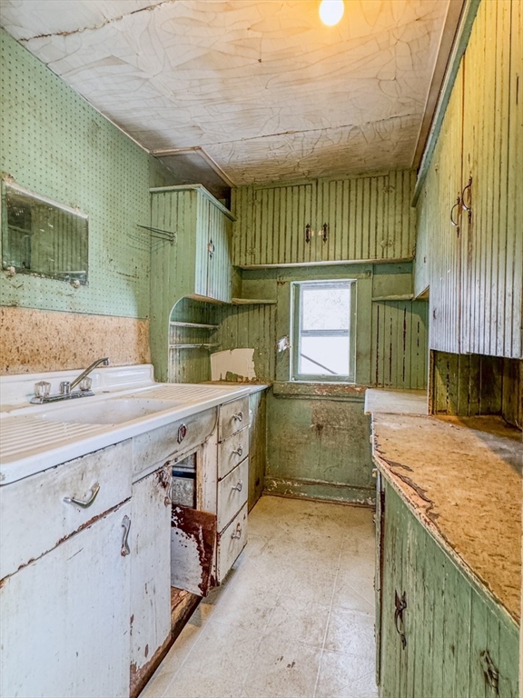 360 Davis Street Greenfield, MA 01301 - Photo 12 of 32 a kitchen with a stove a sink and a refrigerator