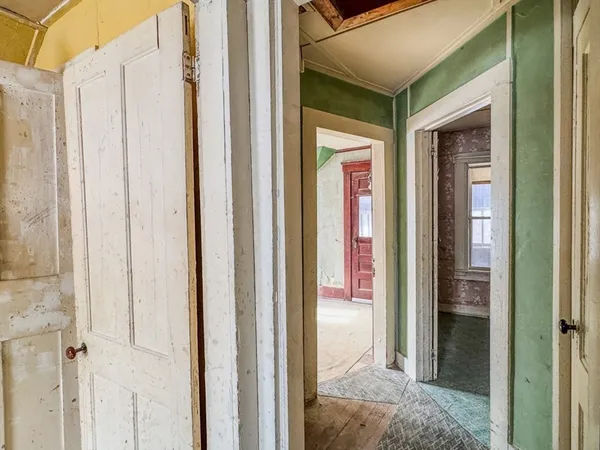 an empty room with window front door