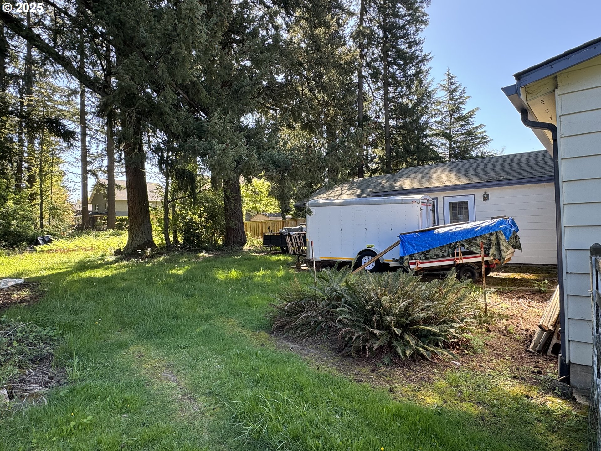2075 Ostman Road West Linn, OR 97068 - Photo 5 of 12 a view of a backyard with table and chairs and potted plants and large trees