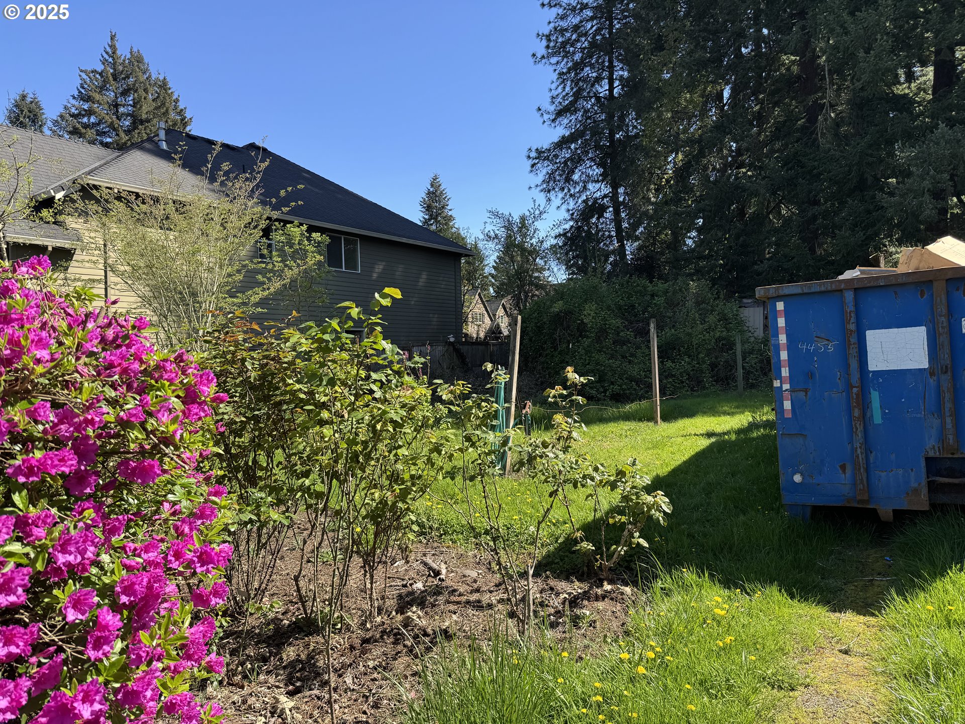 2075 Ostman Road West Linn, OR 97068 - Photo 10 of 12 a view of a house with a yard and garden
