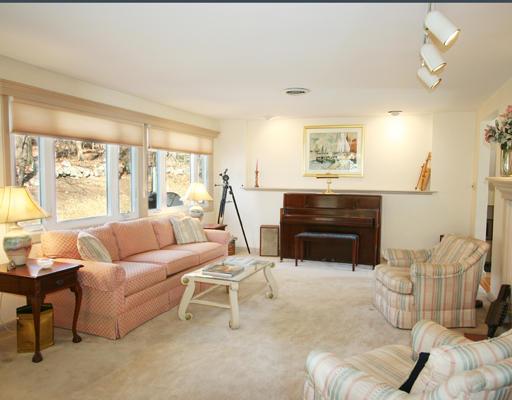 27 Richard Road Needham, MA 02492 - Photo 2 of 10 a living room with furniture a fireplace and a large window