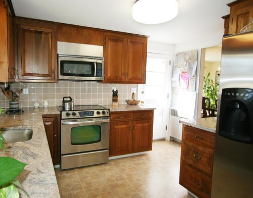 27 Richard Road Needham, MA 02492 - Photo 3 of 10 a kitchen with stainless steel appliances granite countertop a stove a sink and a microwave