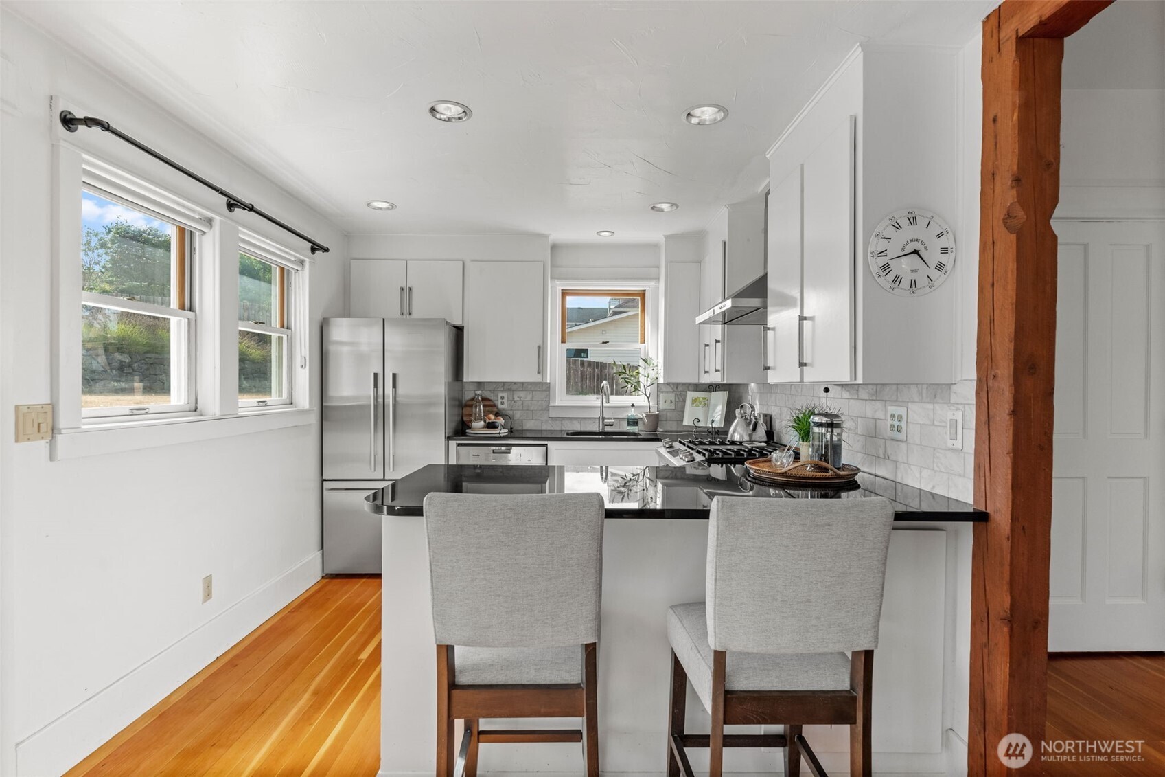 3414 Harborview Drive Gig Harbor, WA 98332 - Photo 19 of 40 a kitchen with a table chairs stove and cabinets