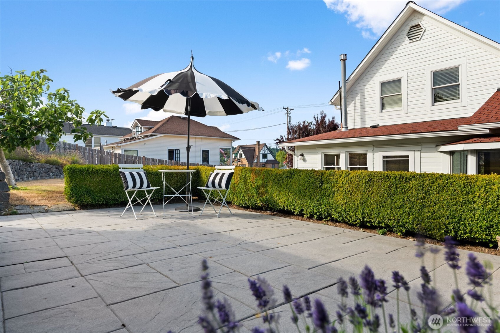 3414 Harborview Drive Gig Harbor, WA 98332 - Photo 35 of 40 a patio with a table and chairs under an umbrella