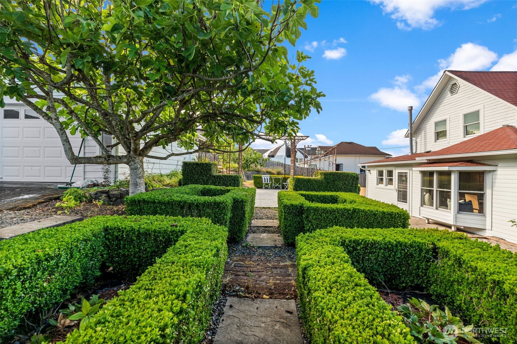 3414 Harborview Drive Gig Harbor, WA 98332 - Photo 37 of 40 a front view of a house with a yard and potted plants