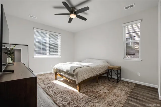 a bedroom with a bed and a desk