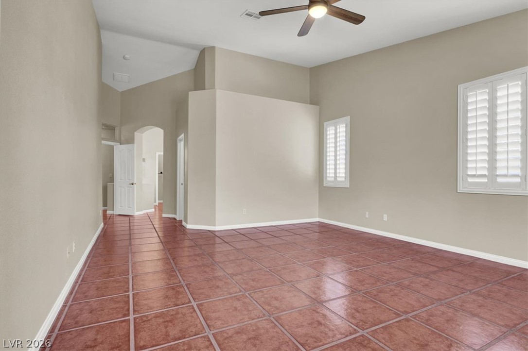 7308 Rustic Meadow Street Las Vegas, NV 89131 - Photo 18 of 27 A spacious room features high vaulted ceilings and durable tile flooring throughout.