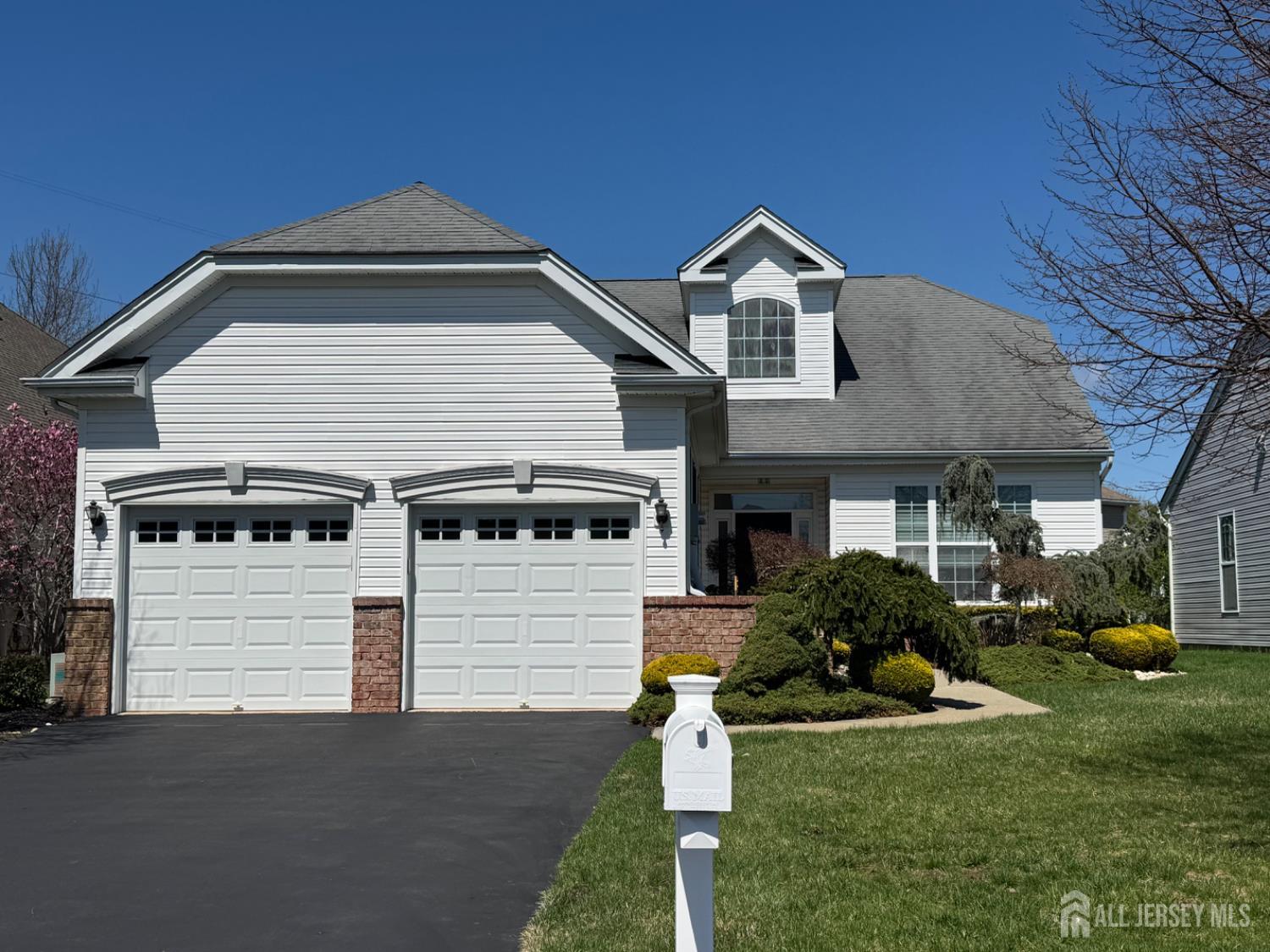 255 Spring Meadow Way Monroe Township, NJ 08831 - Photo 2 of 25 a front view of a house with a yard and garage