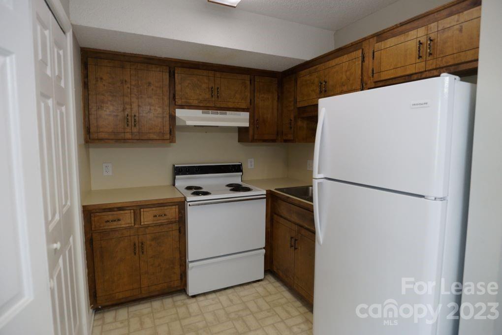 1105 3rd Avenue Southwest Hickory, NC 28602 - Photo 4 of 10 a white refrigerator freezer sitting in a kitchen