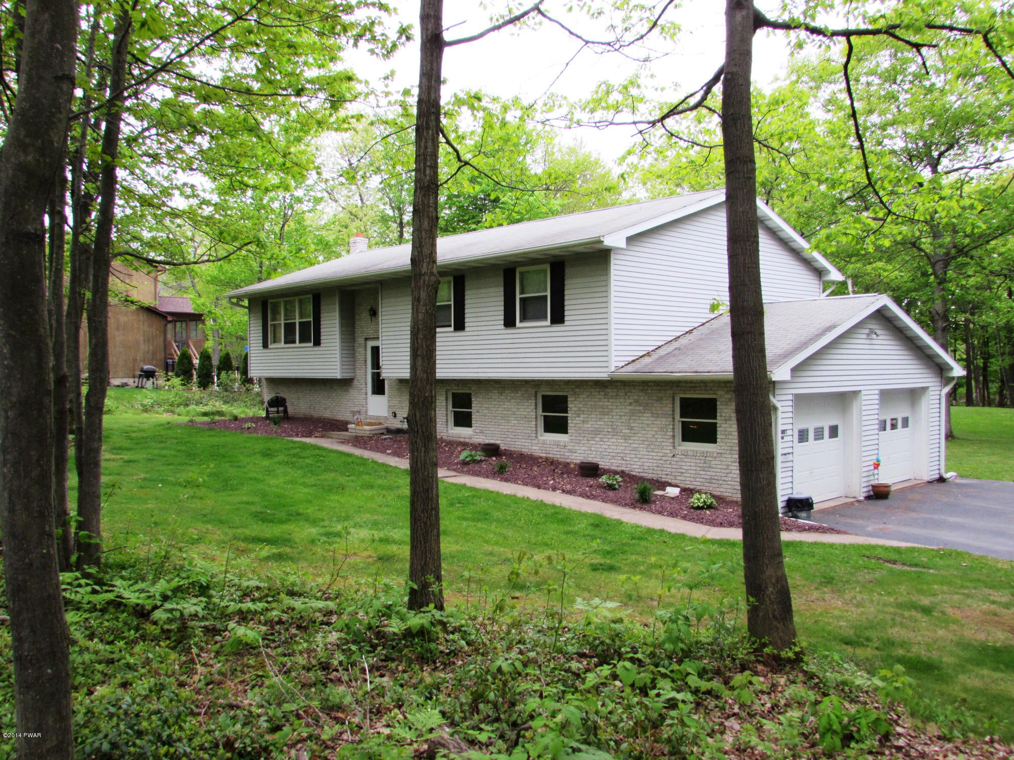 970 Forest Road Lake Ariel, PA 18436 - Photo 3 of 22 a front view of house with yard and green space