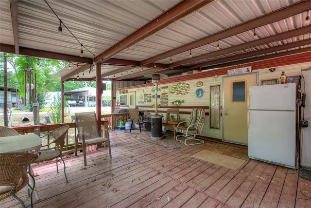 a view of a patio with table and chairs
