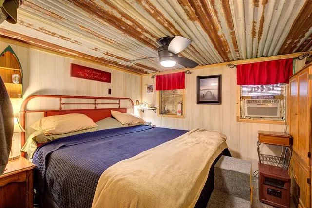 a bed sitting in a bedroom next to a window