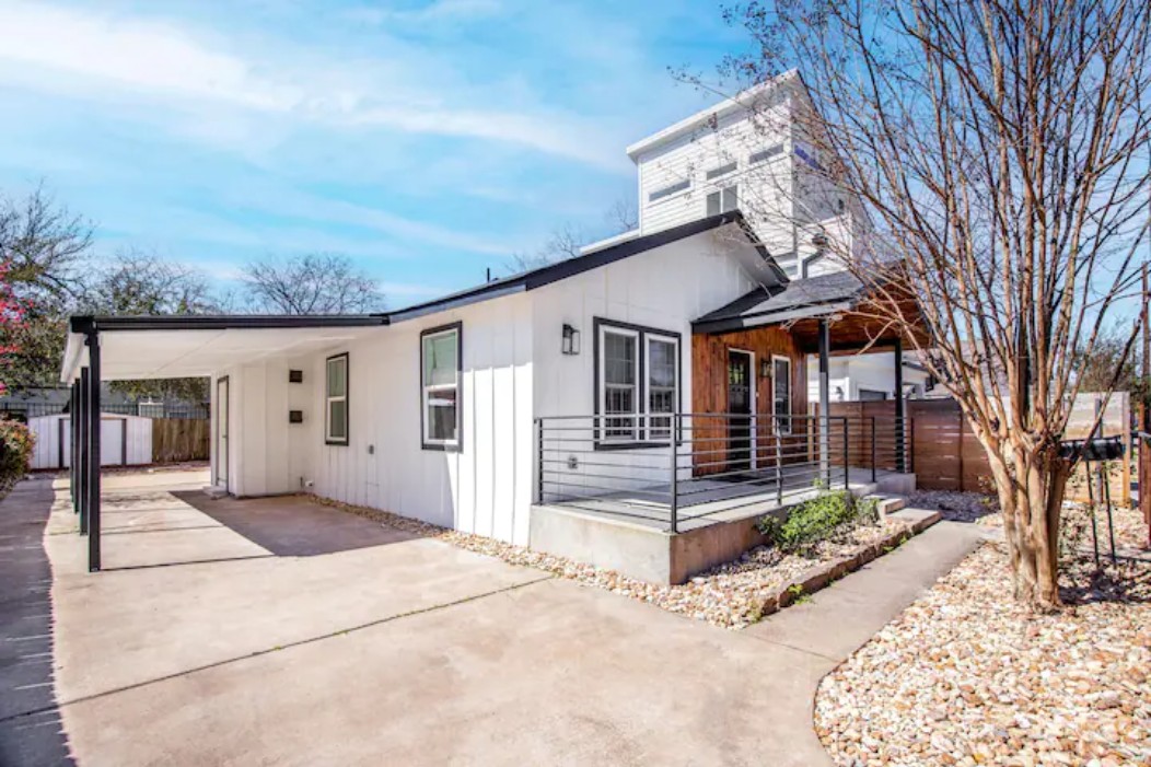 2319 Santa Rita Street Austin, TX 78702 - Photo 20 of 26 View of front facade featuring an attached carport, concrete driveway, and a patio area