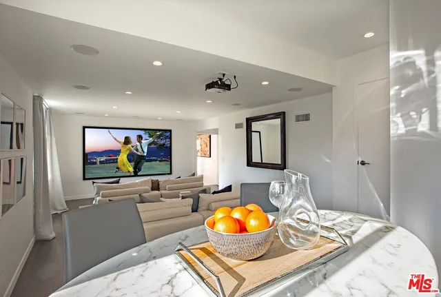a living room with flat screen tv and a table