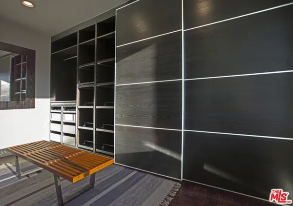 a area with wooden floor and windows