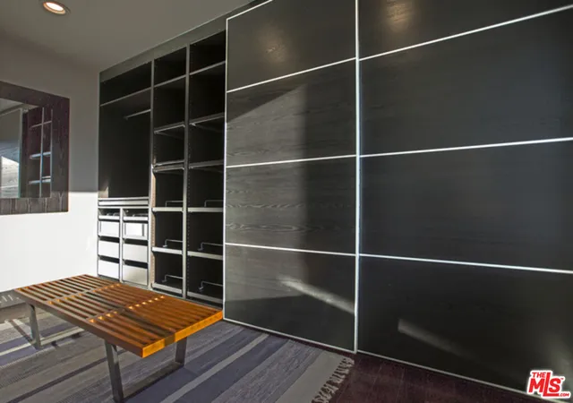 a area with wooden floor and windows