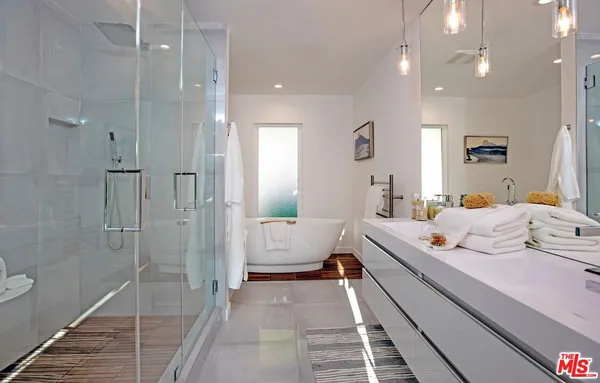 a room with a bed and glass door