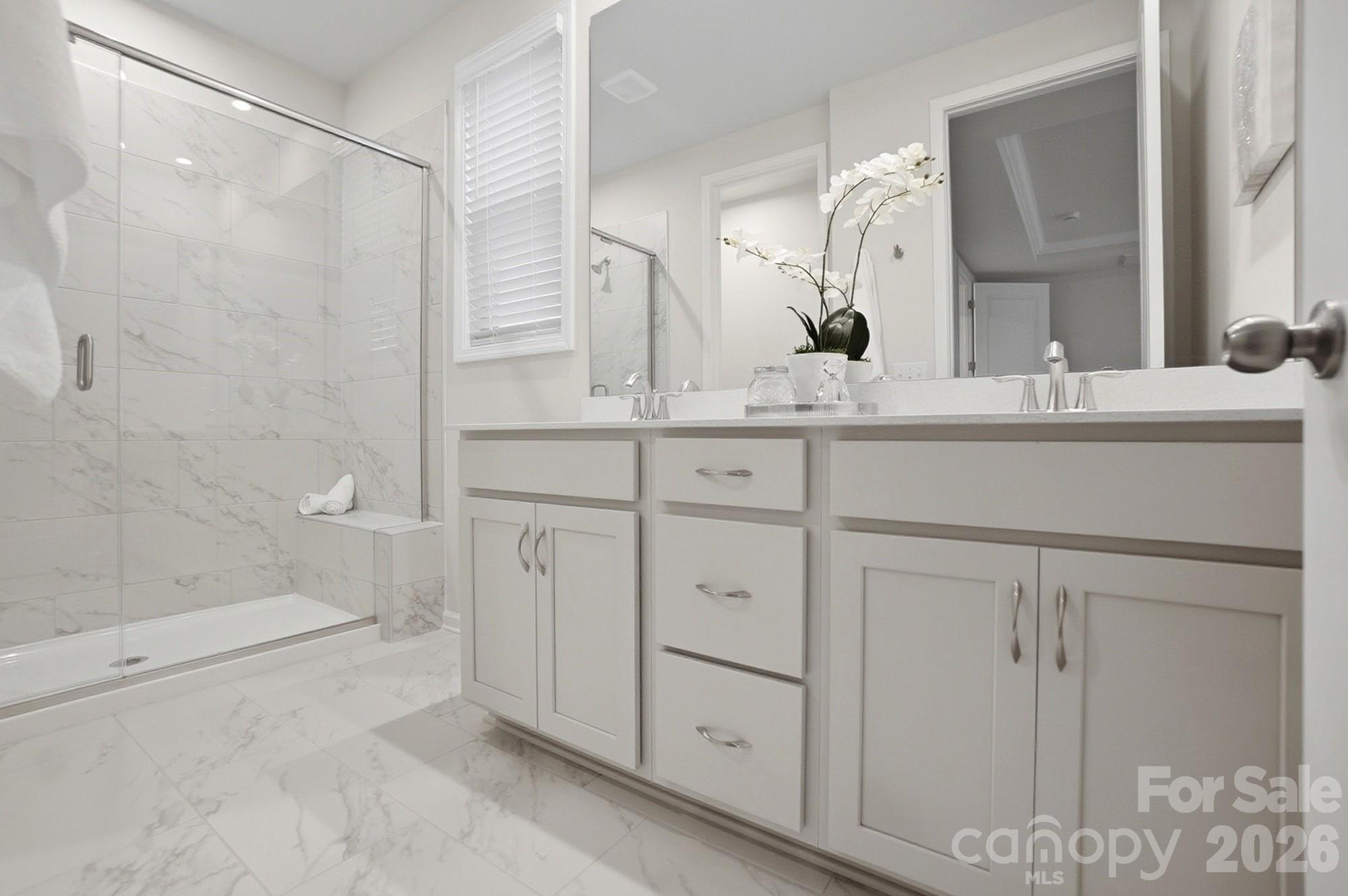 9931 Cask Way Huntersville, NC 28078 - Photo 22 of 42 a bathroom with a double vanity sink a toilet and shower