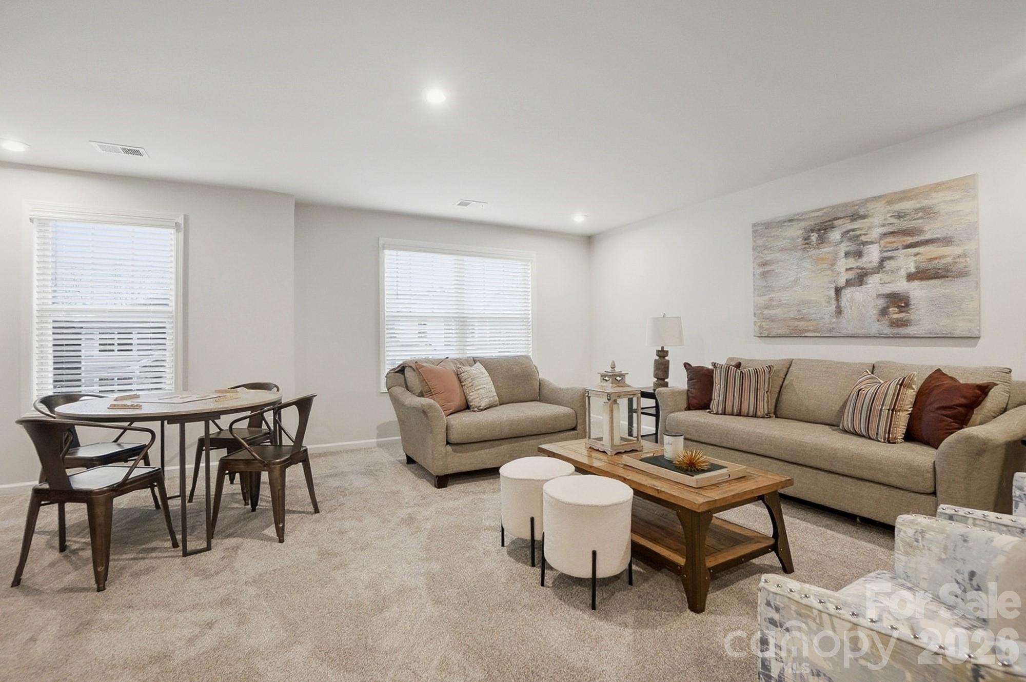 9931 Cask Way Huntersville, NC 28078 - Photo 29 of 42 a living room with furniture a table and a window