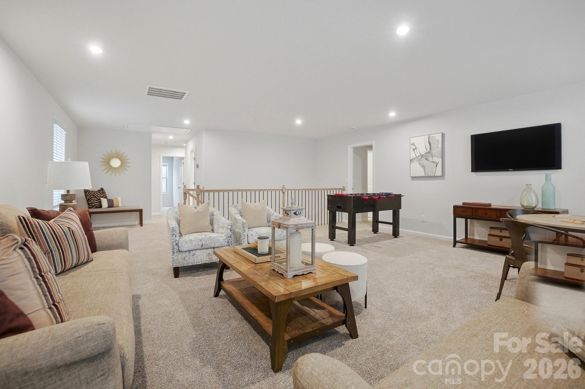9931 Cask Way Huntersville, NC 28078 - Photo 30 of 42 a living room with furniture and a flat screen tv