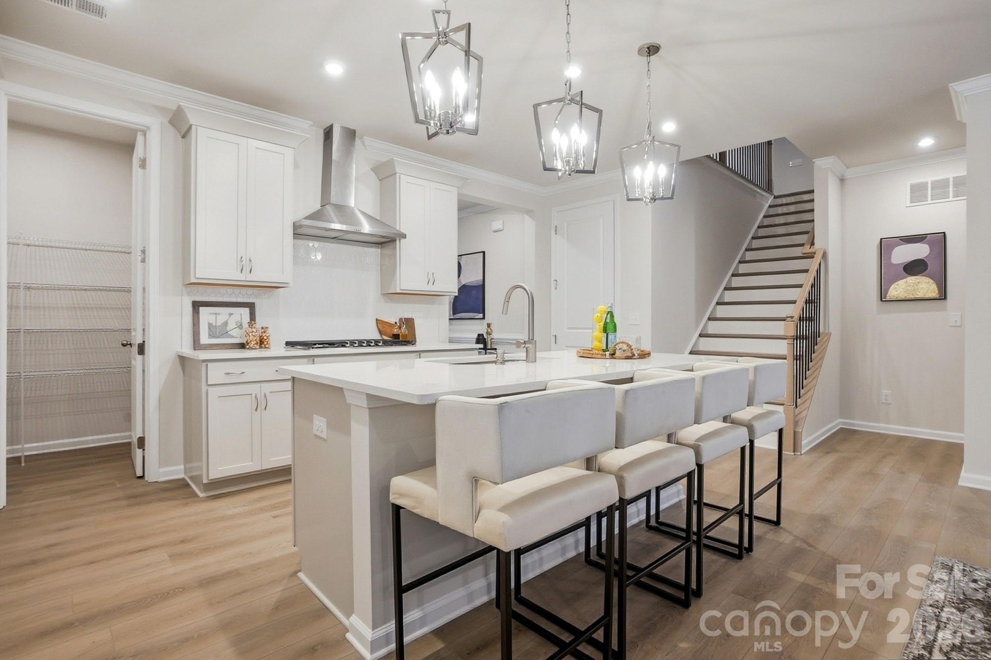 9931 Cask Way Huntersville, NC 28078 - Photo 10 of 42 a kitchen with a sink cabinets and wooden floor