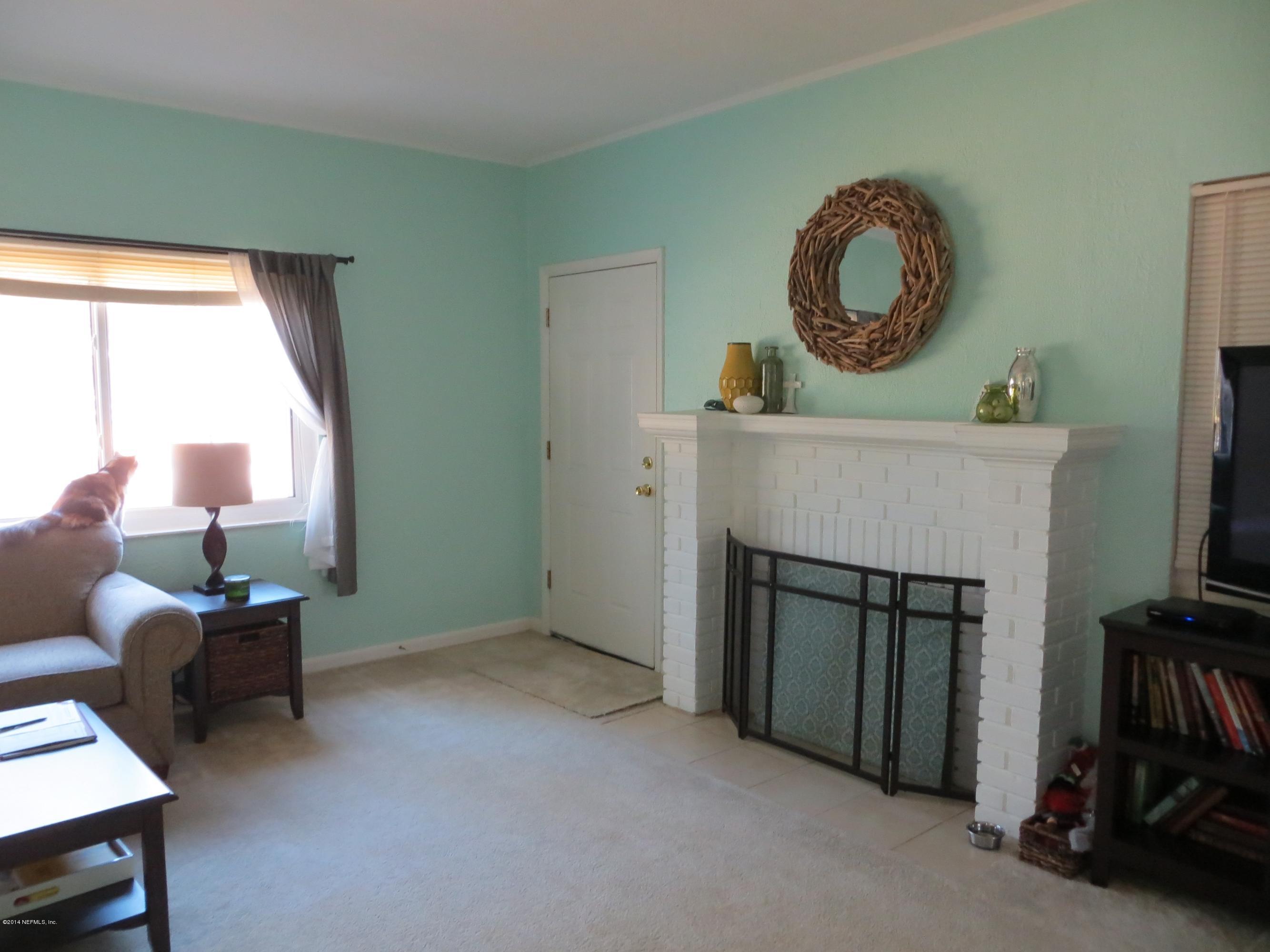 6025 Stetson Road Jacksonville, FL 32217 - Photo 2 of 13 a living room with furniture and a fireplace