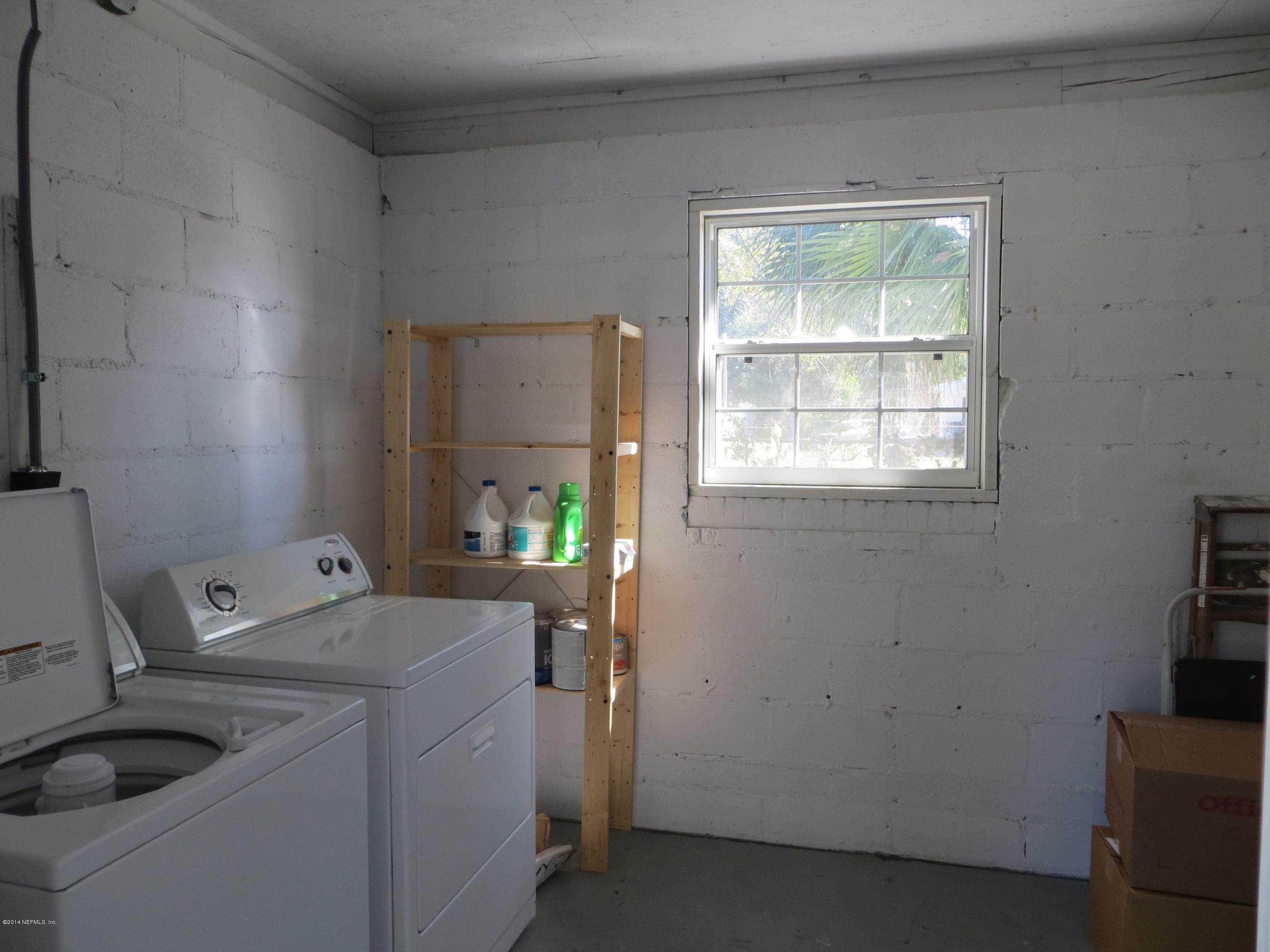 6025 Stetson Road Jacksonville, FL 32217 - Photo 12 of 13 a room with a sink and a washer dryer