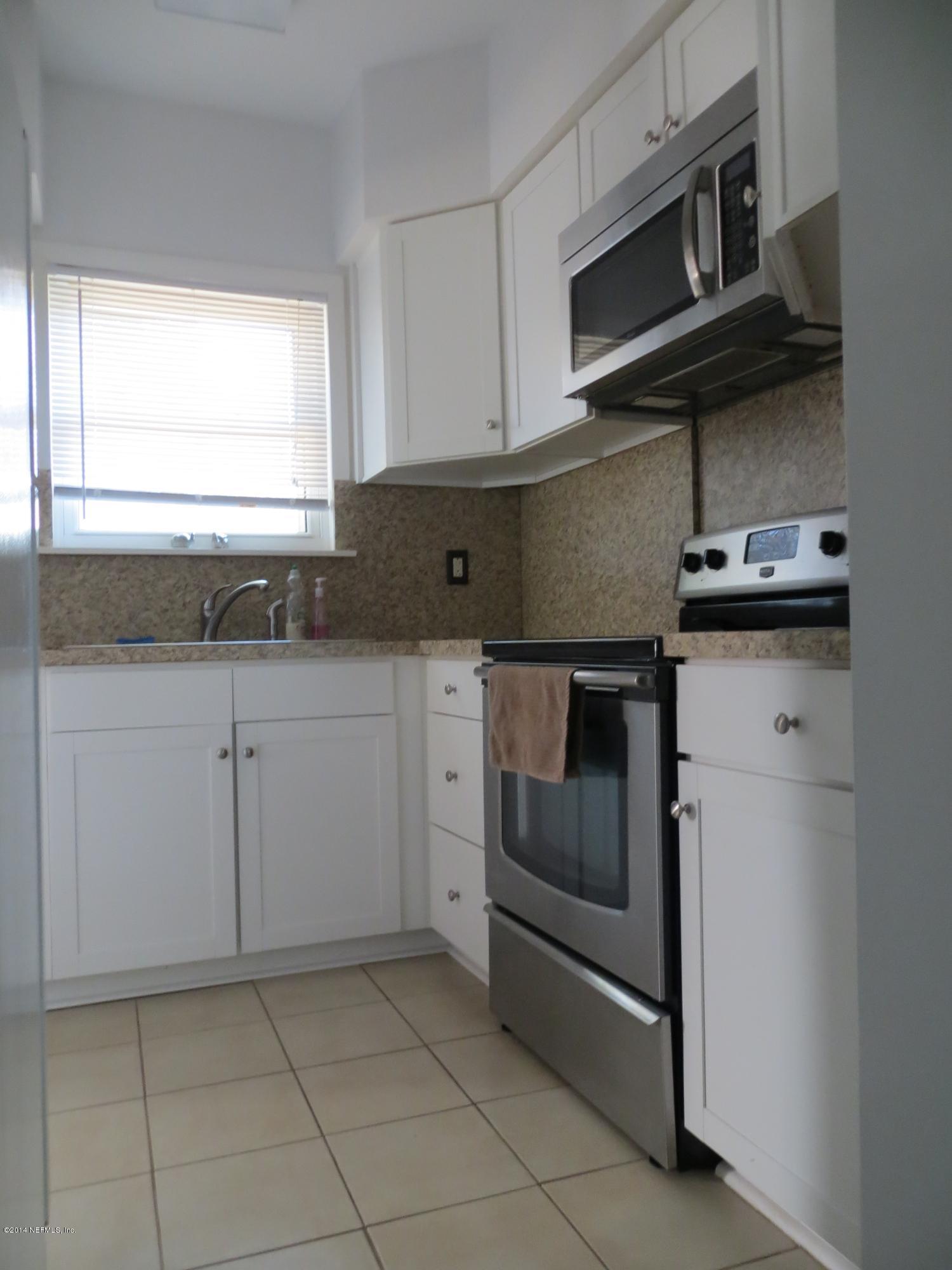 6025 Stetson Road Jacksonville, FL 32217 - Photo 3 of 13 a kitchen with granite countertop white cabinets stainless steel appliances and a sink