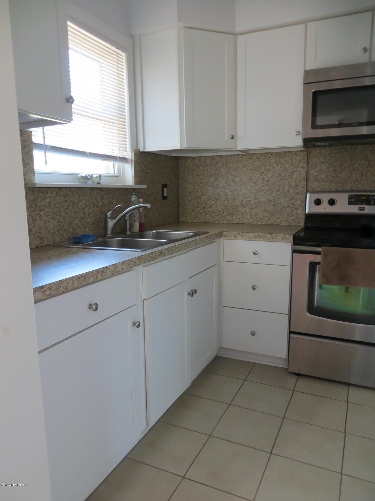 6025 Stetson Road Jacksonville, FL 32217 - Photo 10 of 13 a kitchen with a sink and a stove