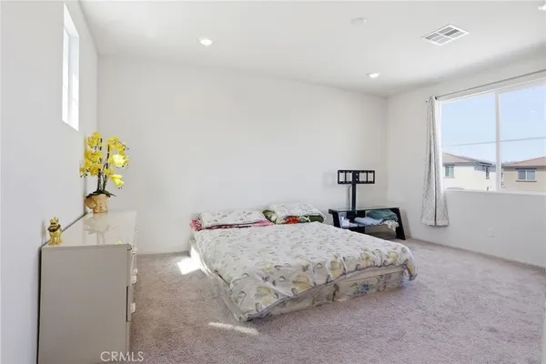 a bedroom with a bed and a window