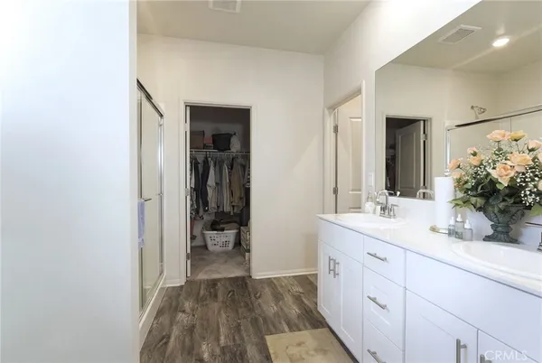 a bathroom with a double vanity sink and mirror