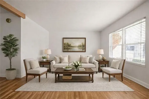 a living room with furniture and a potted plant