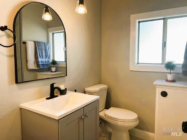 a bath tub sitting next to a white sink and vanity