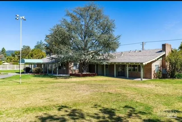 a view of a porch with a floor to ceiling window and potted plants