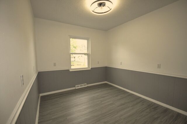 1703 Florence Street Streator, IL 61364 - Photo 12 of 33 an empty room with wooden floor and windows