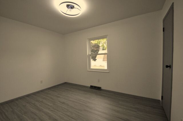 1703 Florence Street Streator, IL 61364 - Photo 15 of 33 an empty room with wooden floor and windows