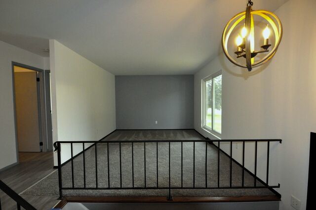 1703 Florence Street Streator, IL 61364 - Photo 3 of 33 a view of staircase with wooden floor and a mirror