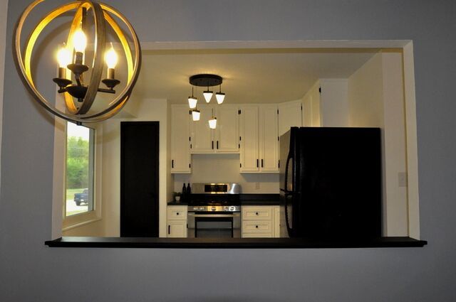 1703 Florence Street Streator, IL 61364 - Photo 6 of 33 a kitchen with a sink a refrigerator and a mirror