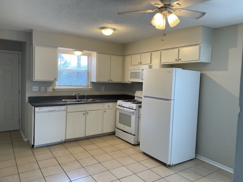 8401 Colony Loop Drive, Unit D Austin, TX 78724 - Photo 3 of 18 a kitchen with appliances cabinets and a sink