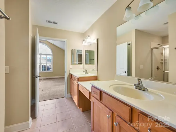 a spacious bathroom with a double vanity sink mirror and